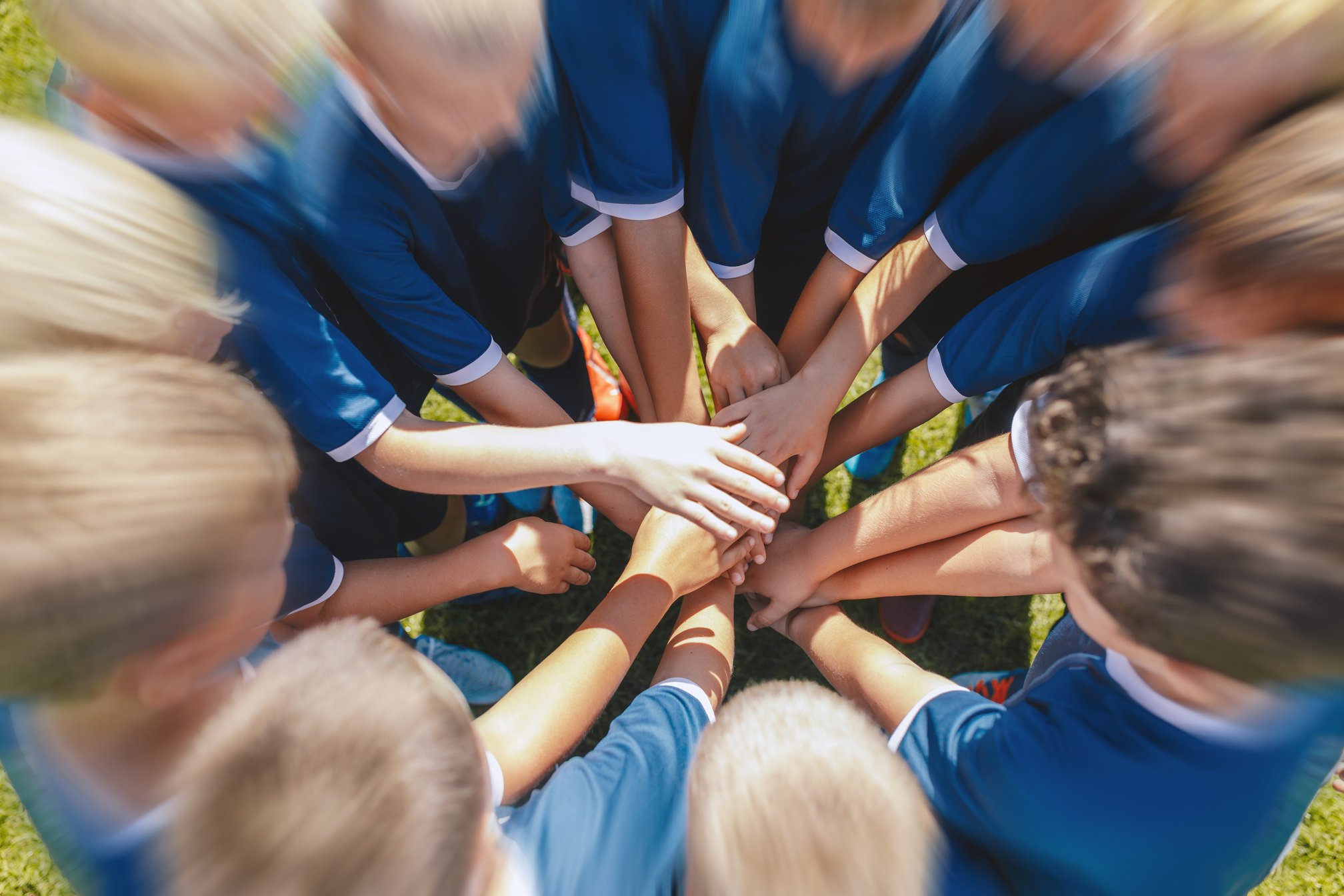 Happy Kids Playing Sports. Hands of Kids Sports Team Stacked on